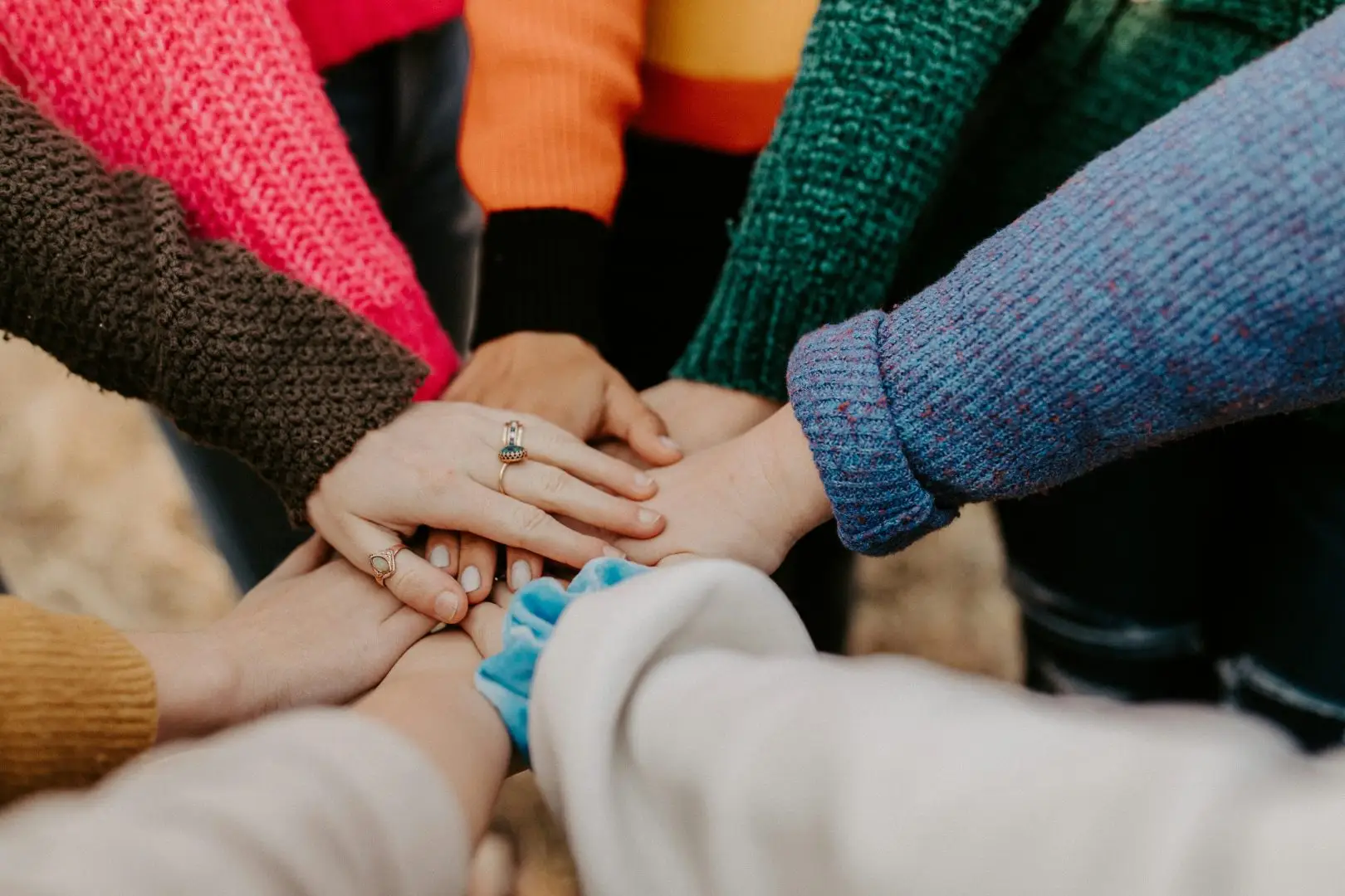 Group of people with their hands together for a huddle