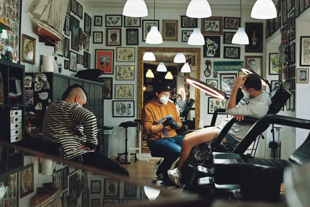 Artist preparing to start a tattoo in a parlor
