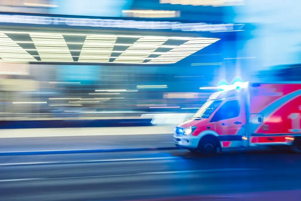 An ambulance driving down the street