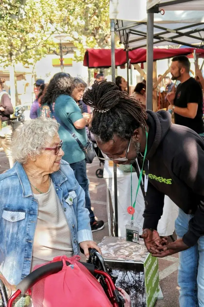 A man talking to an elderly lady at a festival