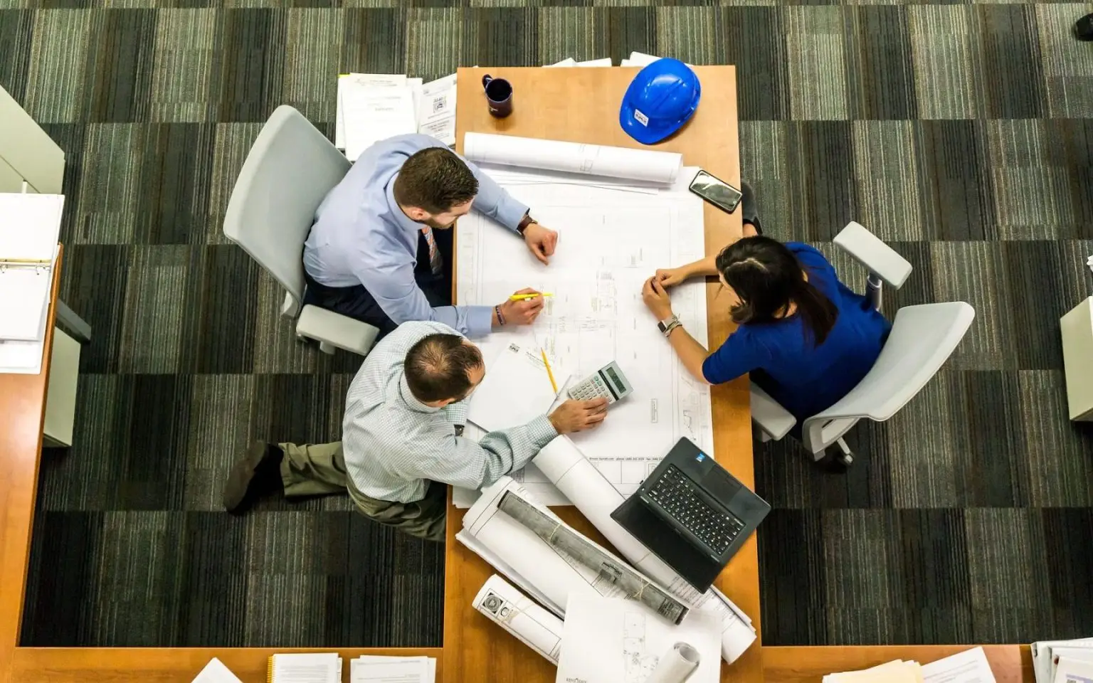 Three people making plans at a table