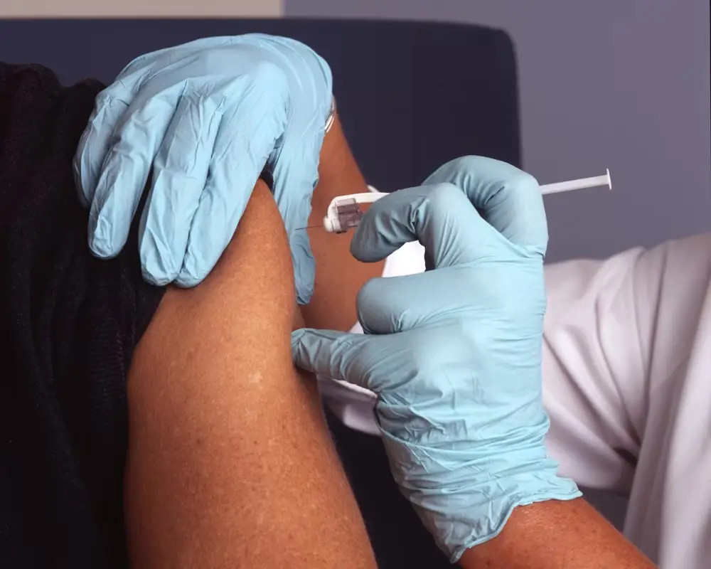 Doctor giving a vaccination with gloves on