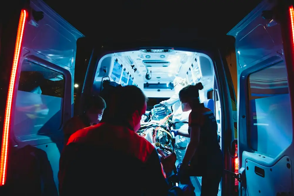 Group of health professionals caring for a patient in an ambulance