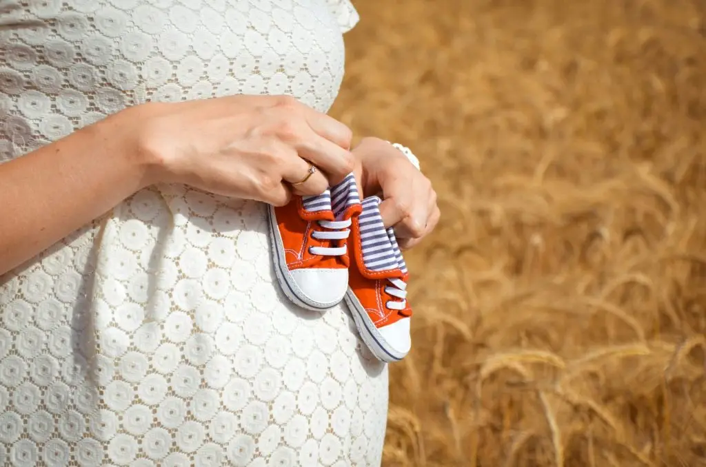 Woman holding baby shoes